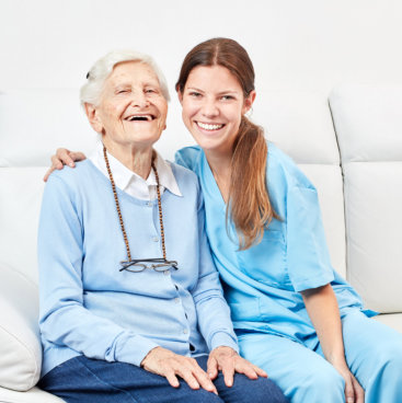 happy elder woman and her caregiver
