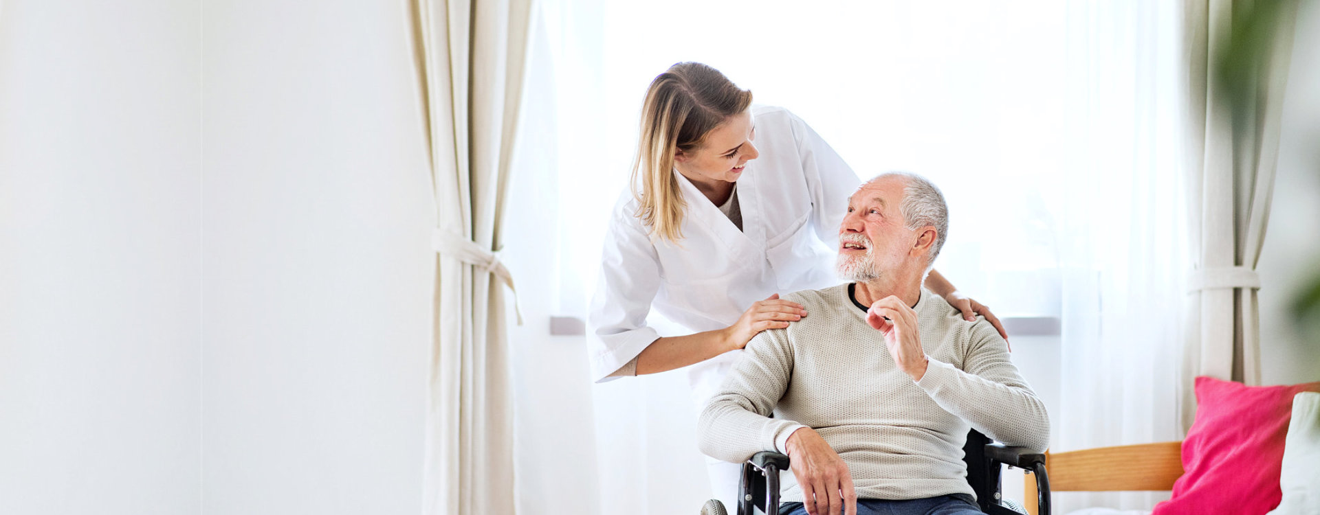 senior man on a wheelchair and his caregiver